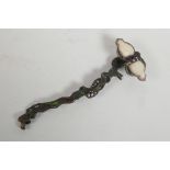 A Chinese bronze ruyi in the form of a branch, set with green and white stones, 10½" long