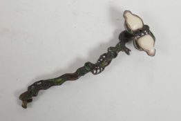 A Chinese bronze ruyi in the form of a branch, set with green and white stones, 10½" long