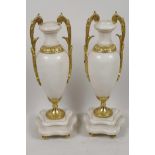 A pair of ormolu mounted white marble side urns on shaped plinth bases, 10½" high