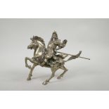 A Chinese silvered metal figure of Guan Gong riding a horse, 7½" x 8"
