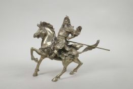 A Chinese silvered metal figure of Guan Gong riding a horse, 7½" x 8"