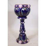 A majolica pedestal and jardiniere, blue ground with pink flowers, 39" high