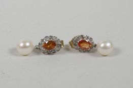 A pair of yellow gold earrings set with a citrine encircled by diamonds with pearl drops