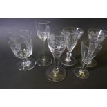 A pair of Georgian engraved conical wine glasses with ribbed bodies and knop stems, and four other