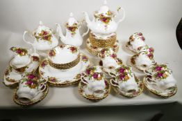 A Royal Albert Old Country Rose porcelain double service comprising two teapots, coffee pot, cream