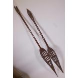 Two Oceana carved hardwood paddle spears, A/F, longest 62"