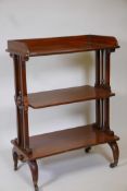 A mahogany three tier buffet with a three quarter gallery, raised on pierced and turned ends