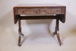 A Regency mahogany sofa table with two true and two false drawers raised on end supports, 33" x