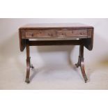 A Regency mahogany sofa table with two true and two false drawers raised on end supports, 33" x