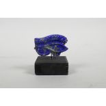 A carved and mounted Lapis Lazuli ornament in the eye of Ra, 2½" high