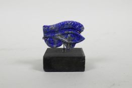 A carved and mounted Lapis Lazuli ornament in the eye of Ra, 2½" high