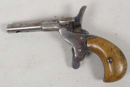 An antique pin fire purse pistol with polished wood handle, the barrel drilled and plugged, 4½?