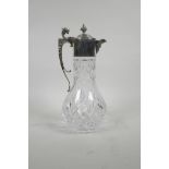 A moulded glass claret jug with silver plated mounts, 12" high