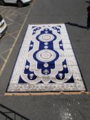 A large Turkish blue ground carpet with all over floral decoration, 118" x 240"
