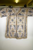 An Islamic linen robe, decorated with black and gilt calligraphy, 41" long