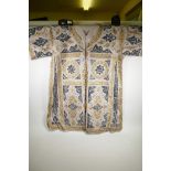 An Islamic linen robe, decorated with black and gilt calligraphy, 41" long