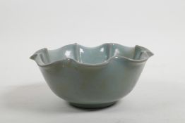 A Chinese celadon glazed porcelain bowl of lotus form, with a frilled rim, 6" diameter