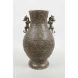 A Chinese archaic bronze two handled vase, 10½" high