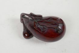 A Chinese carved hardwood box and cover in the form of a gourd, 4½"long