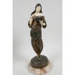 A late C19th bronze and faux ivory figure of a beautiful girl dressed in Arab clothing looking in