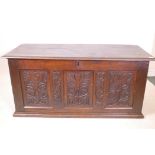 An C18th oak triple panel coffer with carved decoration, 55" x 23" x 25"