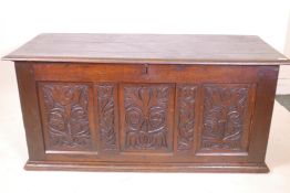 An C18th oak triple panel coffer with carved decoration, 55" x 23" x 25"