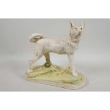 A Royal Dux porcelain figurine of a German Shepherd dog, 9½" long