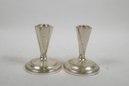 A near pair of Art Deco style sterling silver candlesticks, filled, 4" high