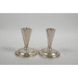 A near pair of Art Deco style sterling silver candlesticks, filled, 4" high