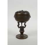A Chinese bronzed metal censer with a pierced cover decorated with dragons, 6" high