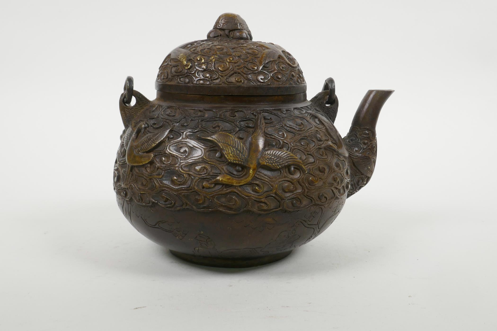 A Chinese bronze teapot with raised decoration of cranes in flight, four character mark to base, 5½" - Image 5 of 6