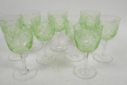 A suite of nine uranium wine glasses star cut decorated on clear stems, 5" high