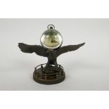 A brass ball desk clock mounted on a stand in the form of an eagle, 5" high x 7" wide