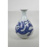 A Chinese blue and white porcelain pear shaped vase decorated with a dragon in flight, six character
