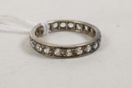 A white metal and diamond set eternity ring
