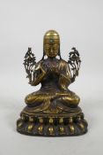 A Sino Tibetan bronze Buddha seated on a lotus throne, with inset stone decoration, 7" high