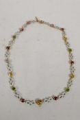 An antique yellow metal necklace with enamelled links and set with precious and semi precious