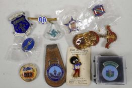 A collection of enamel badges including the Mothers Union, Butlins, Robinsons Marmalade, Masonic etc