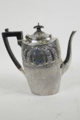 A hallmarked silver coffee pot with whorled chased and engraved decoration with vacant cartouches to