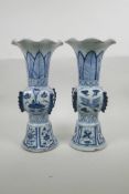 A pair of Chinese blue and white porcelain Ming style gu vases with frilled rims, decorated with