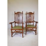 A pair of French late C19th/early C20th oak open armchairs with carved and pierced backs, raised