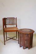 A Kashmiri teak occasional table with brass and copper inlaid top and pierced folding base, and a