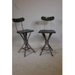 A pair of mid century metal and moulded fibreboard industrial stools, one bears label EMU