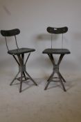 A pair of mid century metal and moulded fibreboard industrial stools, one bears label EMU