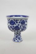 A Chinese blue and white porcelain stem bowl with scrolling floral decoration, four character mark