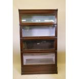 An oak Globe Wernicke bookcase with four sections, base and top, one section lacks scissor action,