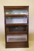 An oak Globe Wernicke bookcase with four sections, base and top, one section lacks scissor action,