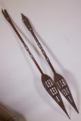 Two Oceana carved hardwood paddle spears, A/F, longest 62"