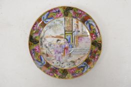 A Cantonese porcelain dish, the gilt border decorated with butterflies, around three women in a