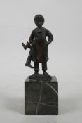 A bronze figure of a young boot maker, 5" high